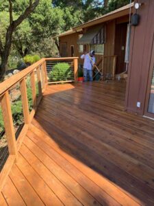 Residential deck builder working on framing and installation of a custom deck
