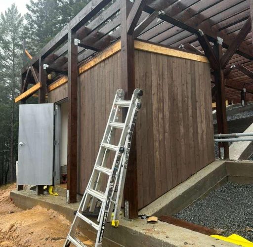 Wood structure exterior finish with framing and siding on hillside construction project